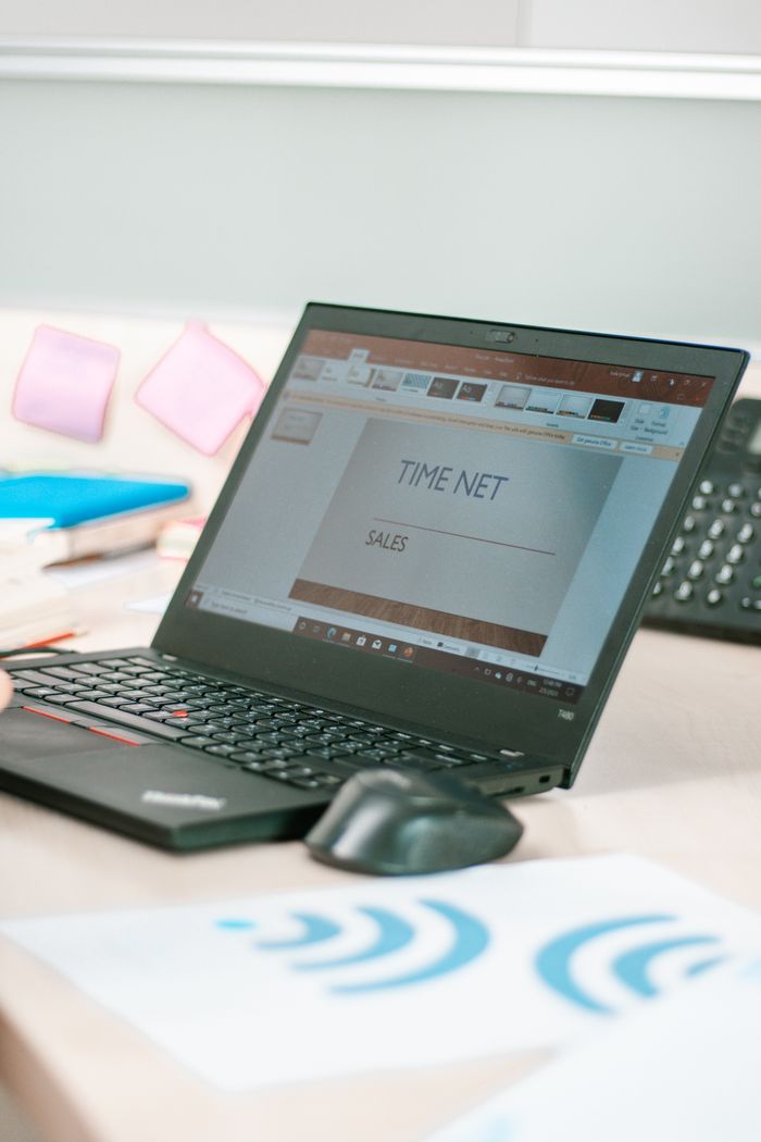 A laptop on a desk displaying a sales presentation, highlighting technology in business.